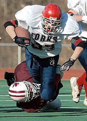 Joe Babcock is tackled by Eden's Matt Haier.