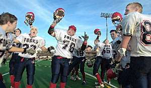 Forks players - Matt Faughnan, 76, taking center stage - celebrate their semi-final victory over Eden of Section 6.
