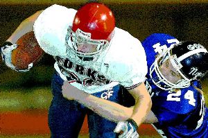 Chenango Forks' Zach Vredenburgh strains for extra yardage while being tackled by Norwich's Paul Zakrevsky in the second quarter of Friday night's Section 4 Class B football championship at Binghamton Alumni Stadium. Vredenburgh scored the Blue Devils' first touchdown on a 53-yard pass reception