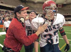 Assistant coach Dave Hogan congratulates Chris Pease, middle, and an emotional Joe Babcock moments after the Blue Devils won the Class B state football championship.