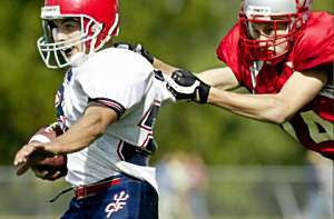 The good guys' Drew Hessney gets pulled down in the fourth quarter by Chenango Valley's Matt Hiser. Drew ran for 43 yards, part of CF's 326-yard rushing attack that keyed the Blue Devils' 49-0 road victory.