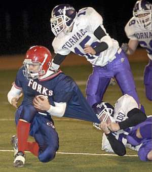 Chenango Forks quarterback Tim Batty is pulled down by Norwich's Blaine Laughlin as teammate Anthony Muserallo closes in during the second half of Friday's Class B football championship at Union-Endicott