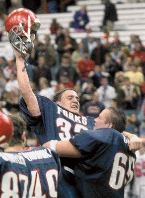 Joe Nicholson, left, gets a lift from teammate Josh Cary after Chenango Forks beat Hornell, 21-20, in the Class B state semifinal game Saturday in Syracuse. - DIOGENES AGCAOILI JR. / Press & Sun-Bulletin