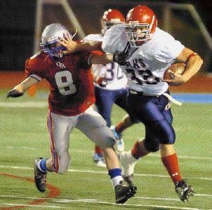 CFs' Tyler Spencer, right, pushes off Owego's Gene Tirinato in the first quarter of Friday night's game at Binghamton's Alumni Stadium. - Diogenes Agcaoili Jr., Binghamton Press & Sun-Bulletin