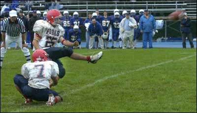 The Blue Devil's Dylan Warner kicks the winning field goal out of the hold of Bryan Lance with five seconds left at Maine-Endwell.