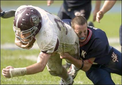 Chenango Forks' Drew Pero tries to stop Corning East's Alex Hamilton after losing his helmet in the third quarter of Saturday's game at Chenango Forks 