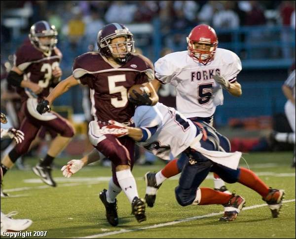 Corning East's Chris Parrillo breaks the tackle of Chenango Forks' Mike Sackett during the first quarter Friday at Corning East High School.